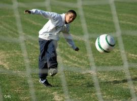Boys through the nets of soccer goals (HQ)